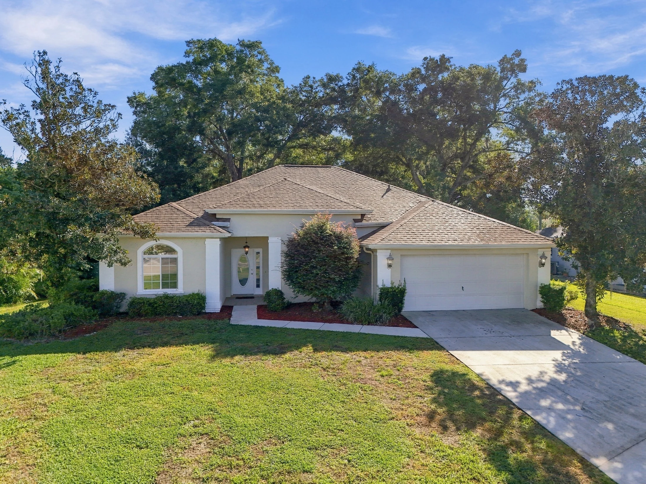 Frontal drone view of a home with a tiled roof