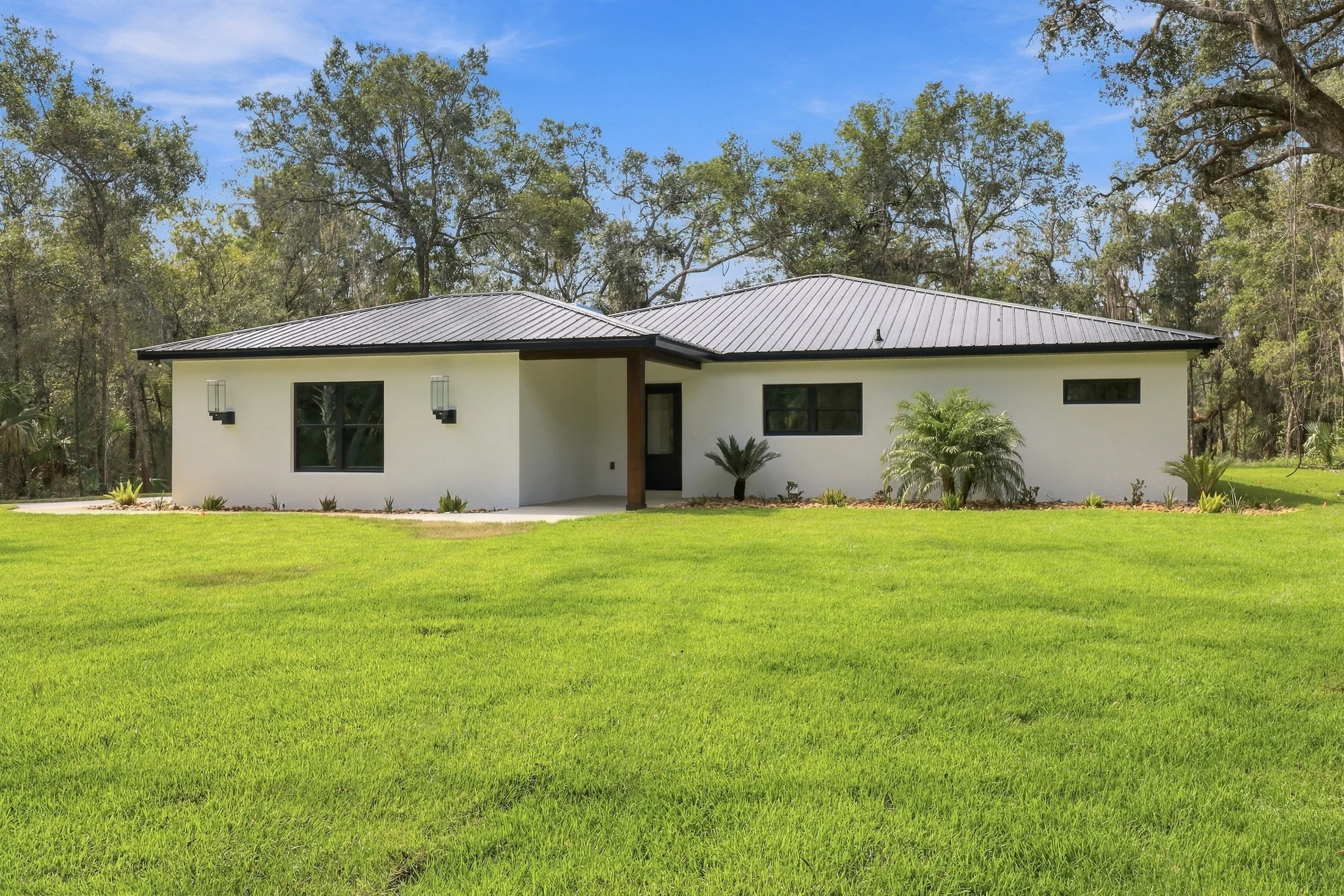 Front elevation with a covered entrance and green lawn